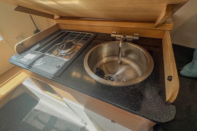 Slide: The Image of Compact kitchen area in 2024 Nimbus Commuter 9 with stove and sink. - 20