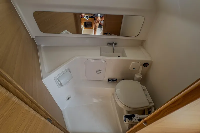 Slide: The Image of 2024 Nimbus Commuter 9 boat bathroom with compact sink and toilet. - 21