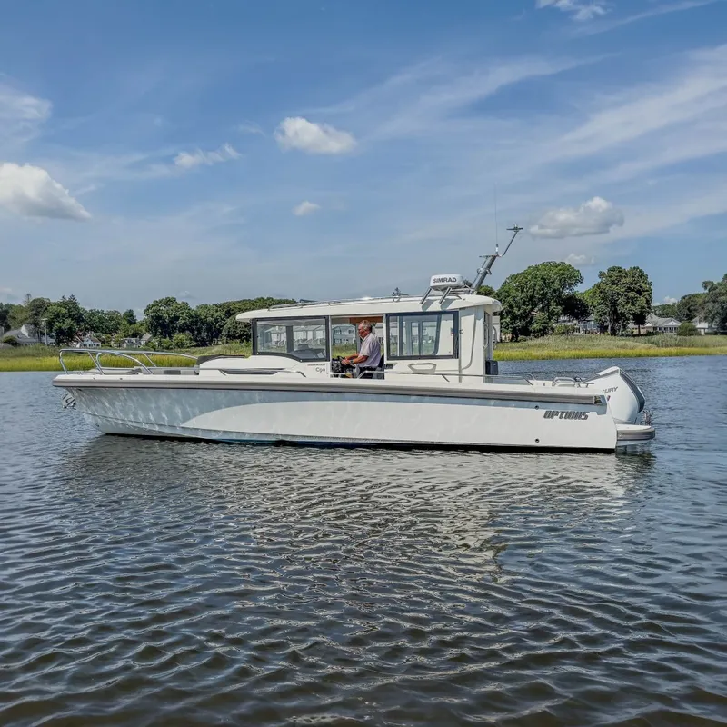 The Image of A 2024 Nimbus Commuter 9 cruising on calm water. The sky is clear and sunny. - 0