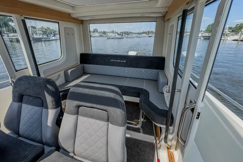Slide: The Image of Interior of 2024 Nimbus Commuter 9 boat with seating and water view. - 16