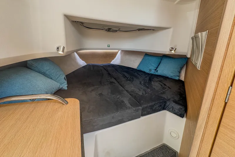 Slide: The Image of 2024 Nimbus Commuter 9 cabin interior with cozy bedding and modern design. - 19