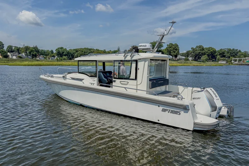 Slide: The Image of 2024 Nimbus Commuter 9 boat on calm water, showcasing sleek design and modern features. - 6