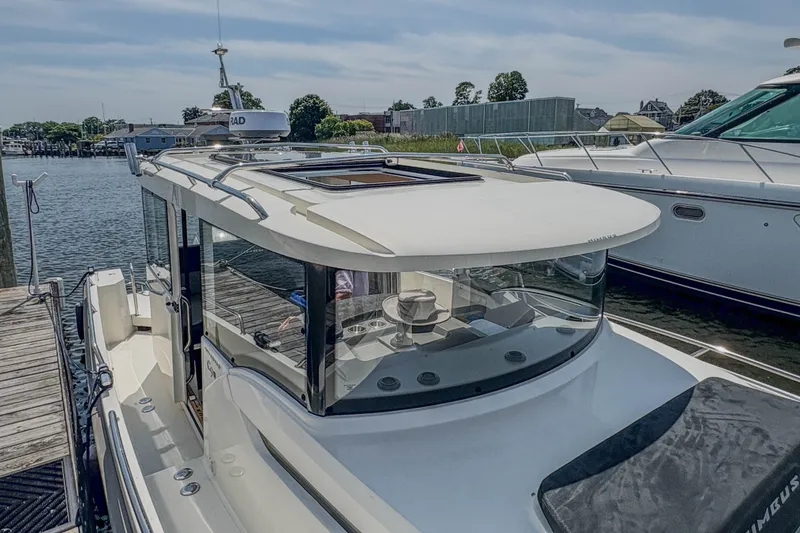 Slide: The Image of 2024 Nimbus Commuter 9 boat docked, showcasing sleek design and modern features. - 10