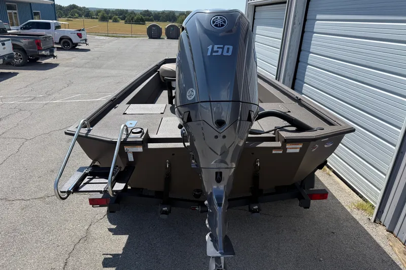 Slide: The Image of Avid 20 Rogue CC 2027 boat with Yamaha 150 engine in parking lot. - 3