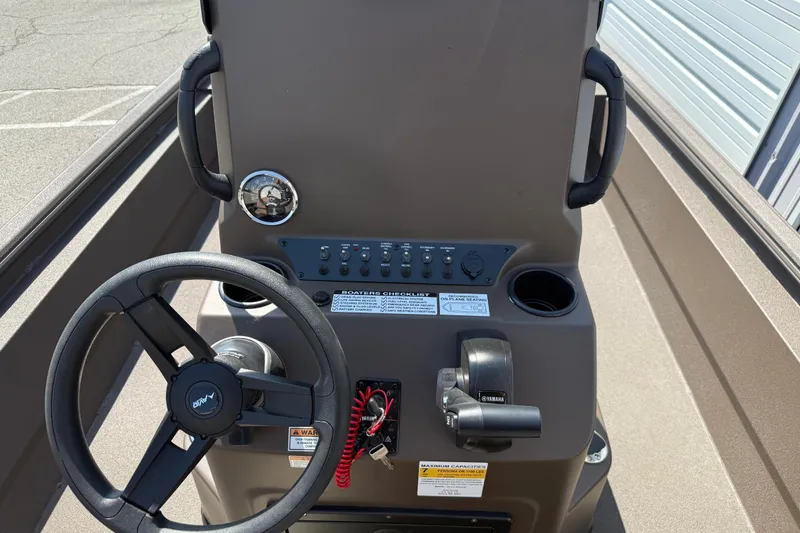 Slide: The Image of Steering console of 2027 Avid 20 Rogue CC boat with controls and gauges. - 13