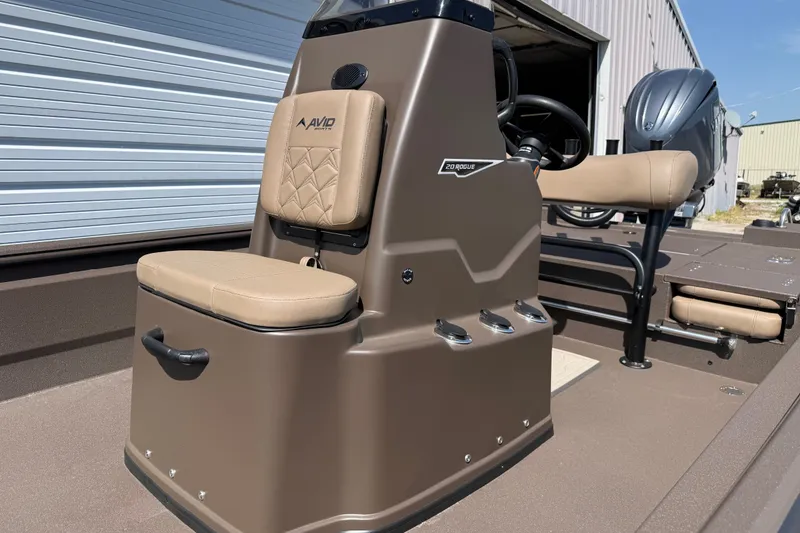 Slide: The Image of Avid 20 Rogue CC 2027 boat interior with tan seating and steering console. - 6