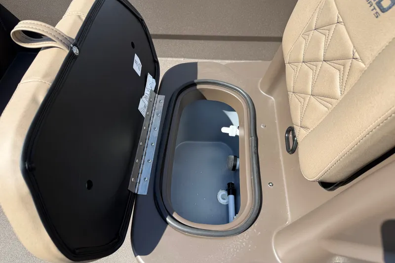Slide: The Image of Open storage compartment in 2027 Avid 20 Rogue CC boat with beige seating. - 11