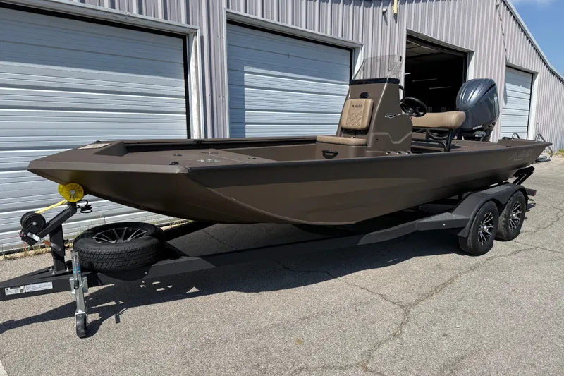 Slide: The Image of 2027 Avid 20 Rogue CC boat on trailer, parked outside metal building. - 4