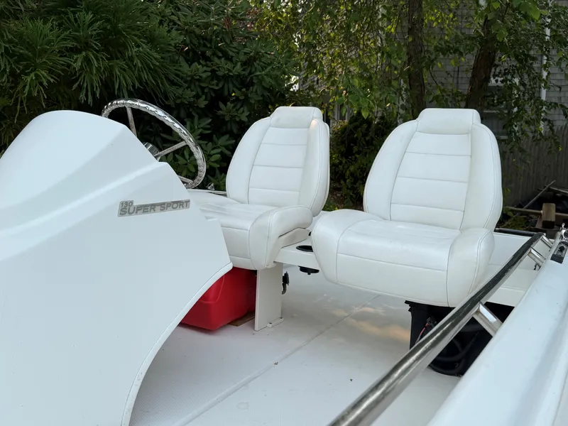 Slide: The Image of The image shows the cockpit of a 2017 Boston Whaler 130 Super Sport with two white seats. - 2