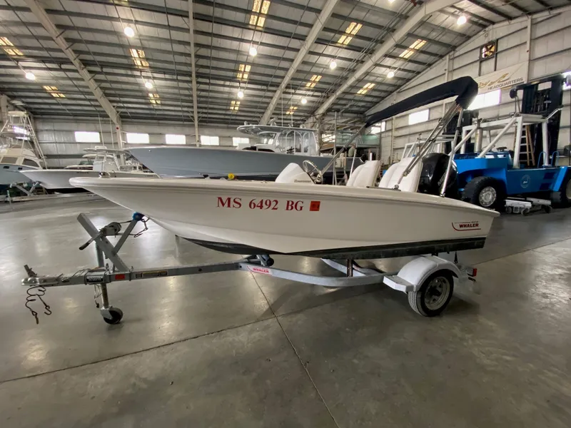 Slide: The Image of 2017 Boston Whaler 130 Super Sport on a trailer in a warehouse. - 4