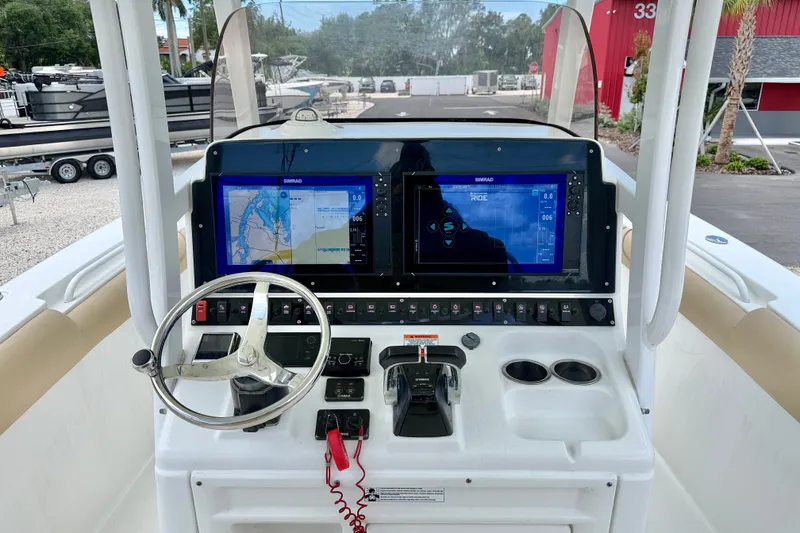 Slide: The Image of 2016 Sea Hunt Gamefish 30 helm with dual Simrad displays and steering wheel. - 13