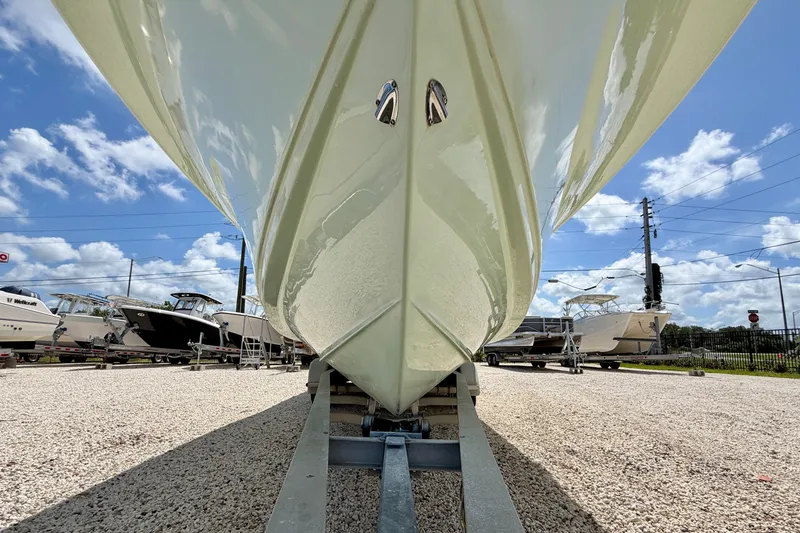 Slide: The Image of 2016 Sea Hunt Gamefish 30 boat on trailer under clear blue sky. - 33