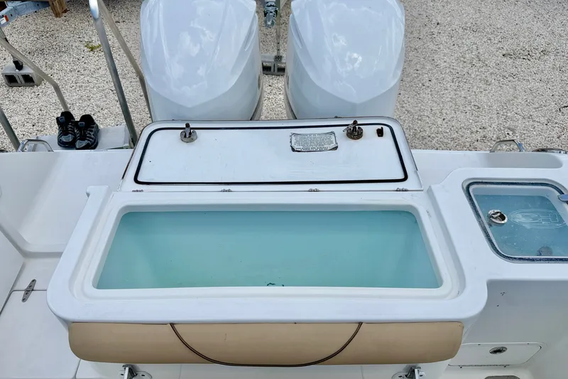 Slide: The Image of 2016 Sea Hunt Gamefish 30 boat with open livewell and dual engines. - 29