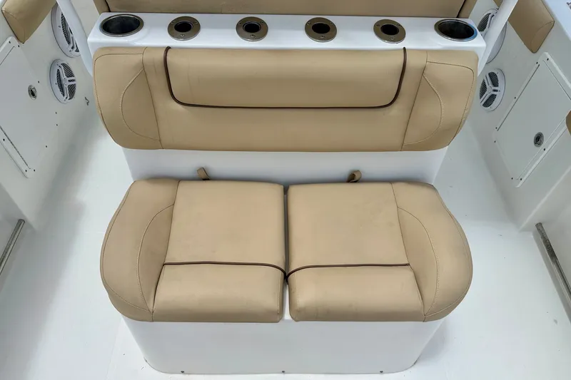 Slide: The Image of 2016 Sea Hunt Gamefish 30 boat seating with beige cushions and cup holders. - 25