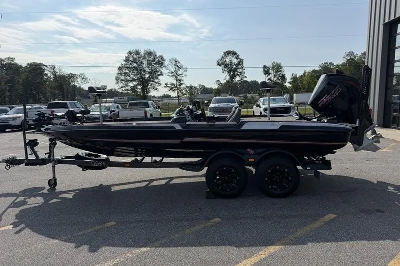 The Image of 2023 Bass Cat Puma STS boat on trailer in parking lot, side view. - 0