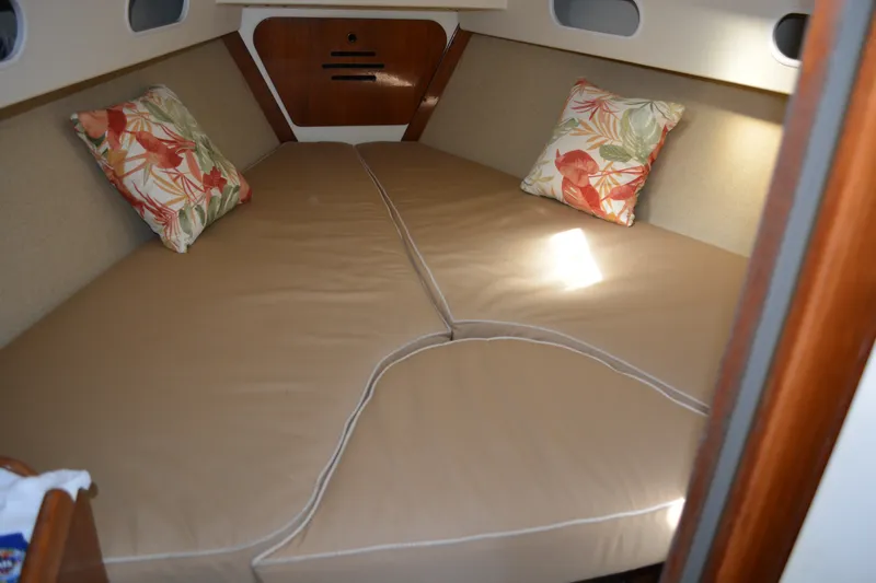 Slide: The Image of Cozy cabin interior of 1984 Pearson 303 sailboat with floral pillows and beige cushions. - 14
