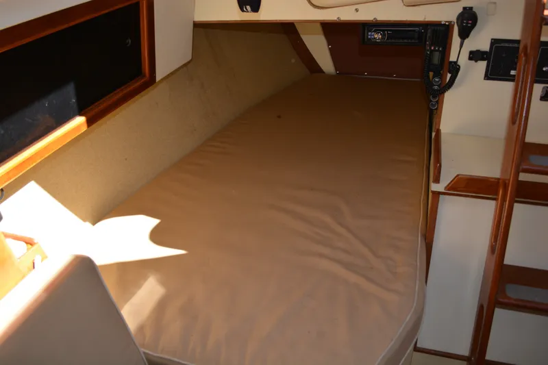 Slide: The Image of Interior cabin of a 1984 Pearson 303 sailboat with a cushioned berth. - 17