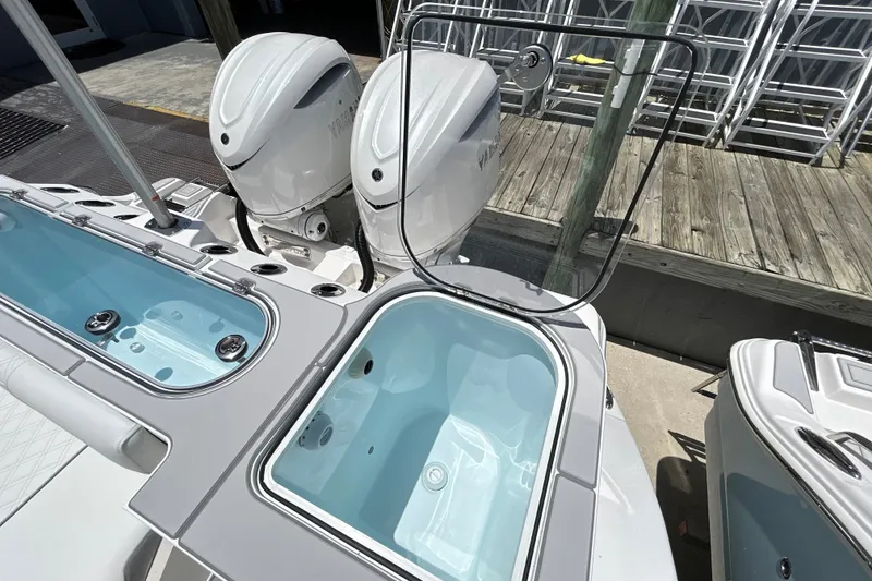 Slide: The Image of 2027 Sea Fox 328 Commander boat with dual outboard engines and open storage compartments. - 16