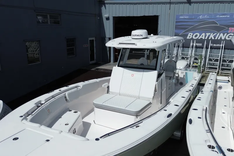 Slide: The Image of 2027 Sea Fox 328 Commander boat displayed at a marina, featuring a sleek design. - 37