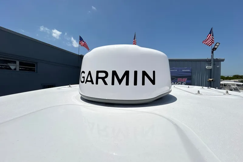Slide: The Image of Garmin radar on 2027 Sea Fox 328 Commander boat, with American flags in the background. - 30