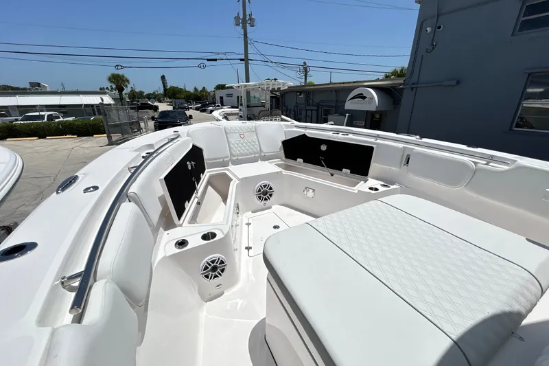 Slide: The Image of 2027 Sea Fox 328 Commander boat interior with white seating and storage compartments. - 21
