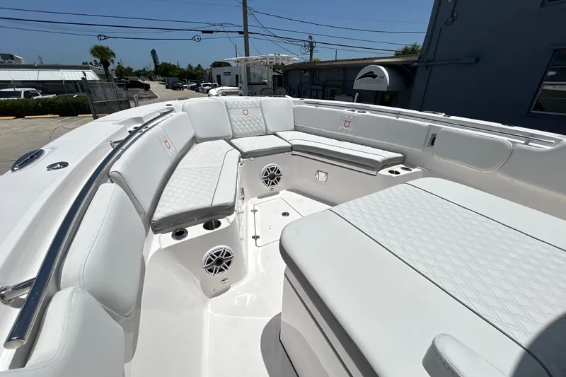 Slide: The Image of Luxurious seating area on a 2027 Sea Fox 328 Commander boat, featuring white upholstery. - 25