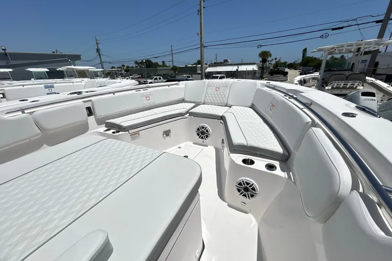 Slide: The Image of Luxurious seating area on a 2027 Sea Fox 328 Commander boat, featuring white upholstery. - 27