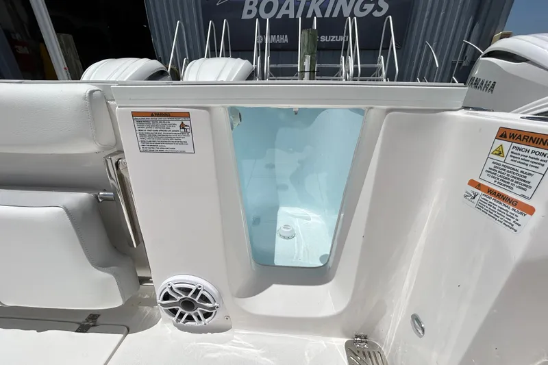 Slide: The Image of 2027 Sea Fox 328 Commander boat interior with storage compartment and warning labels. - 14