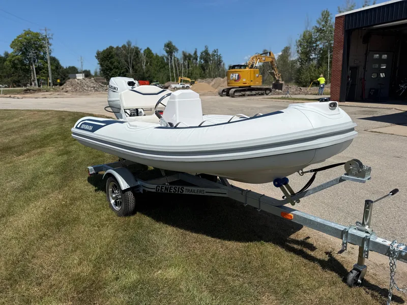 Slide: The Image of Novurania 335DL inflatable boat on a trailer outdoors. - 13