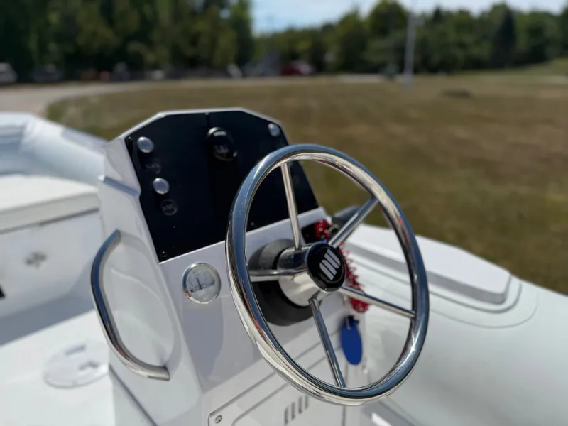 Slide: The Image of Close-up of a Novurania 335DL boat's helm with a shiny steering wheel. - 18