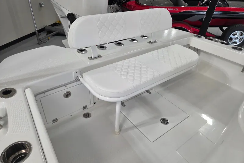 Slide: The Image of 2027 BlackJack 256 Coastal boat interior with white cushioned seating and storage compartments. - 14
