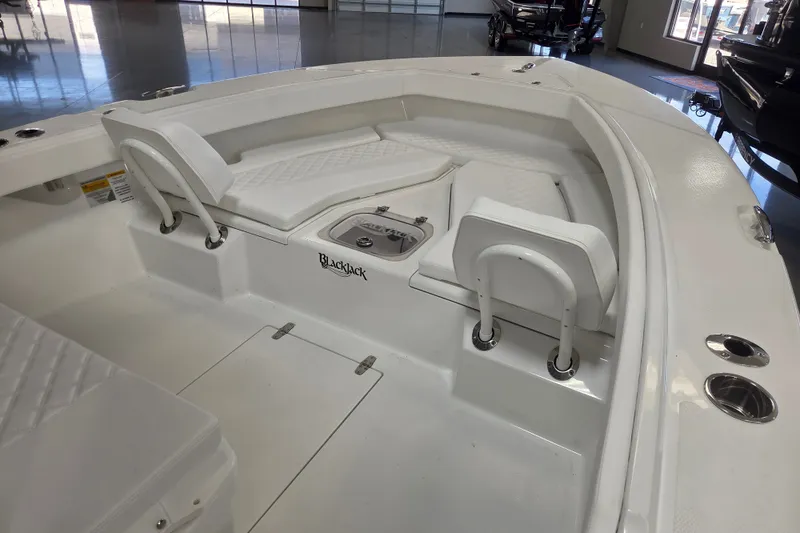 Slide: The Image of Interior view of 2027 BlackJack 256 Coastal boat with white seating and storage compartments. - 9
