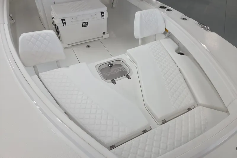 Slide: The Image of 2027 BlackJack 256 Coastal boat interior with quilted white seating and storage. - 10