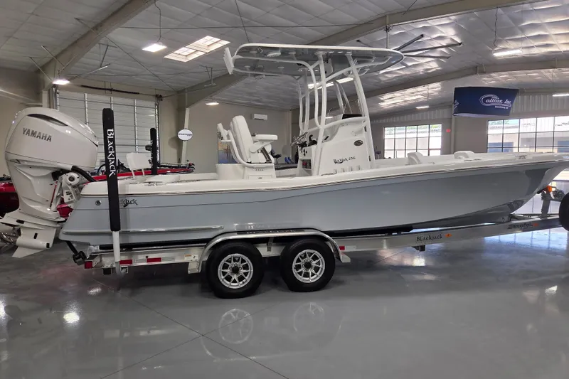 Slide: The Image of 2027 BlackJack 256 Coastal boat on trailer in showroom with Yamaha engine. - 5
