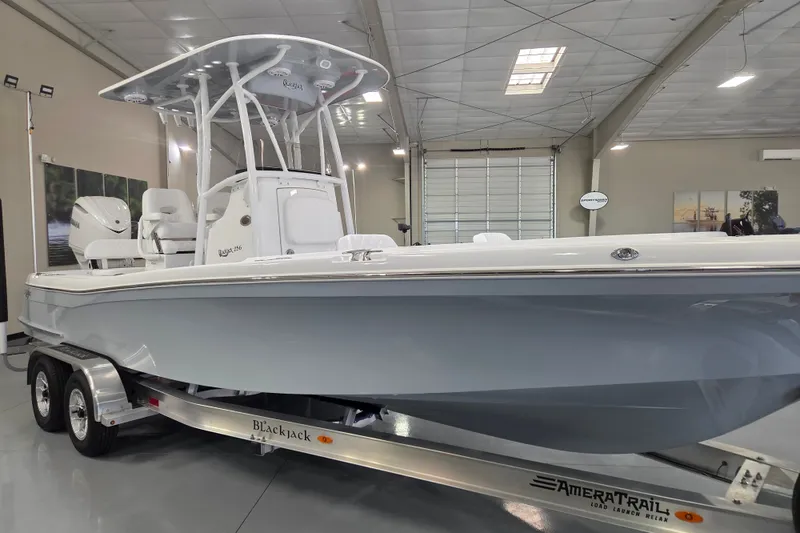 Slide: The Image of 2027 BlackJack 256 Coastal boat on trailer in showroom, featuring sleek design and modern amenities. - 6
