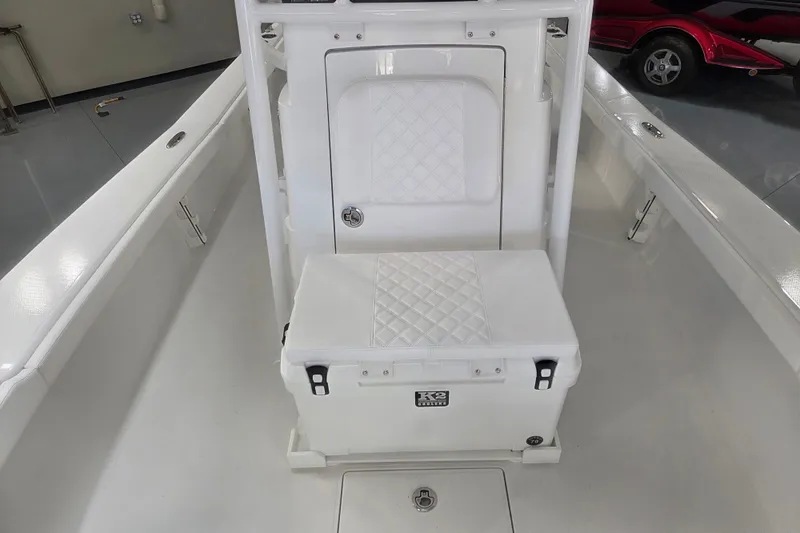 Slide: The Image of Interior of 2027 BlackJack 256 Coastal boat featuring a K2 cooler and storage area. - 8