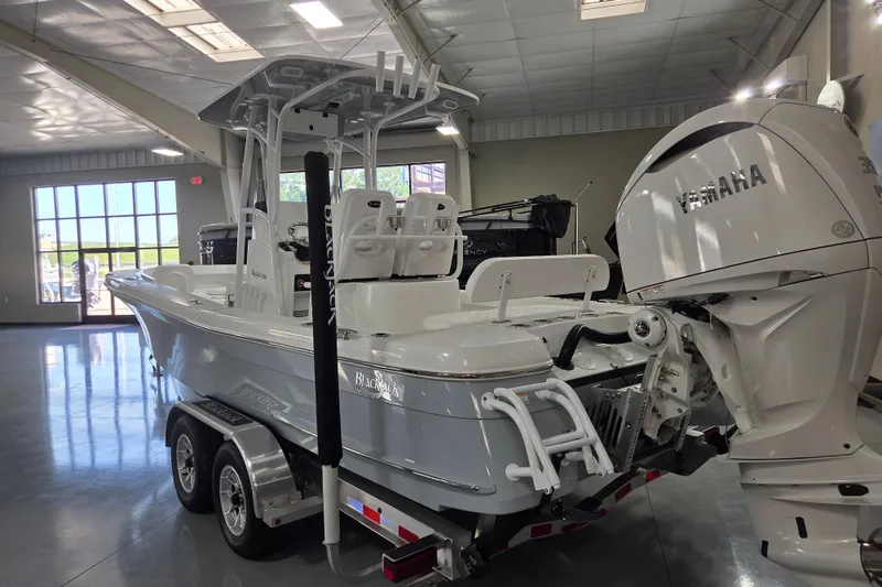 Slide: The Image of 2027 BlackJack 256 Coastal boat with Yamaha engine in showroom. - 2