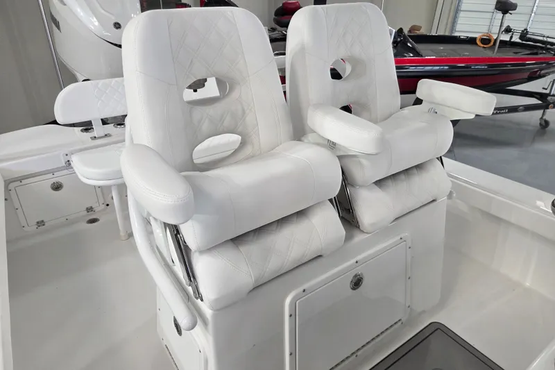 Slide: The Image of Luxury seating on 2027 BlackJack 256 Coastal boat, featuring plush white upholstery and armrests. - 11