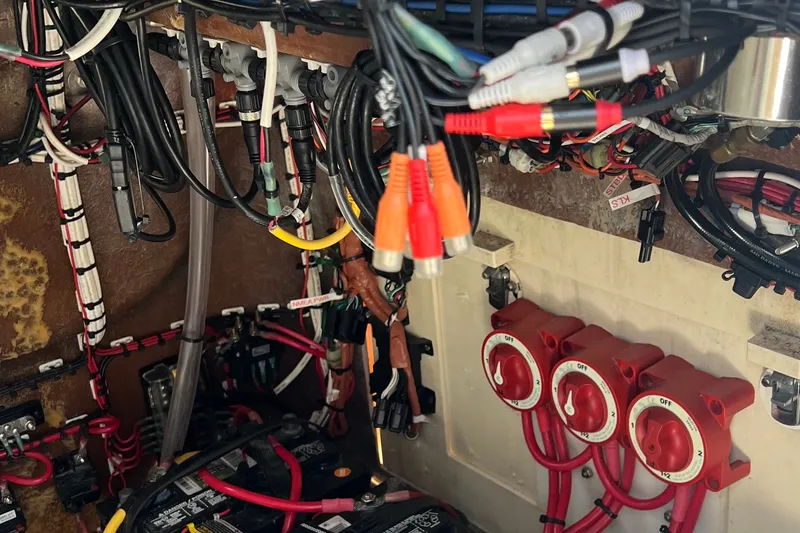 Slide: The Image of Electrical wiring and switches inside a 2000 Cobia 274 Center Console boat. - 17