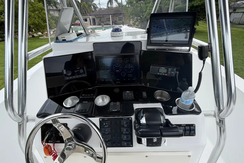 Slide: The Image of Center console of a 2000 Cobia 274 boat with modern navigation equipment. - 9