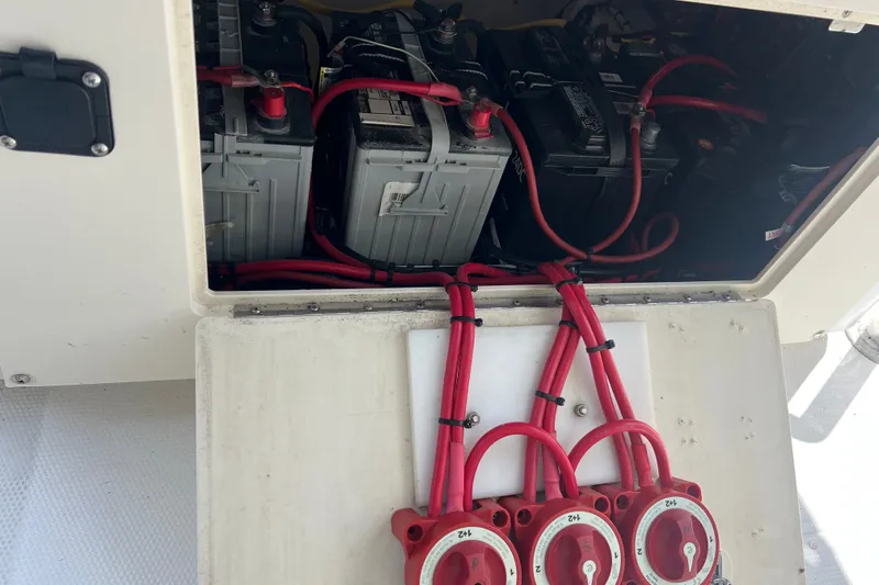 Slide: The Image of Battery compartment of a 2000 Cobia 274 Center Console boat with red cables. - 18