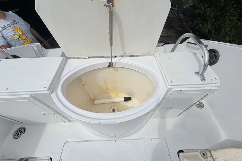 Slide: The Image of Livewell on a 2000 Cobia 274 Center Console boat, open lid, white interior. - 16