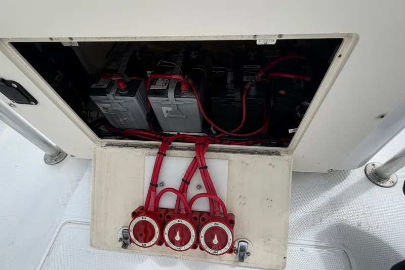 Slide: The Image of Battery compartment of a 2000 Cobia 274 Center Console boat with red wiring. - 4