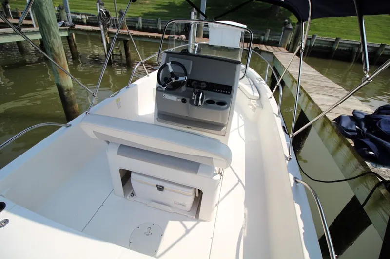 Slide: The Image of 2016 Boston Whaler 210 Dauntless boat interior with steering console and seating. - 10