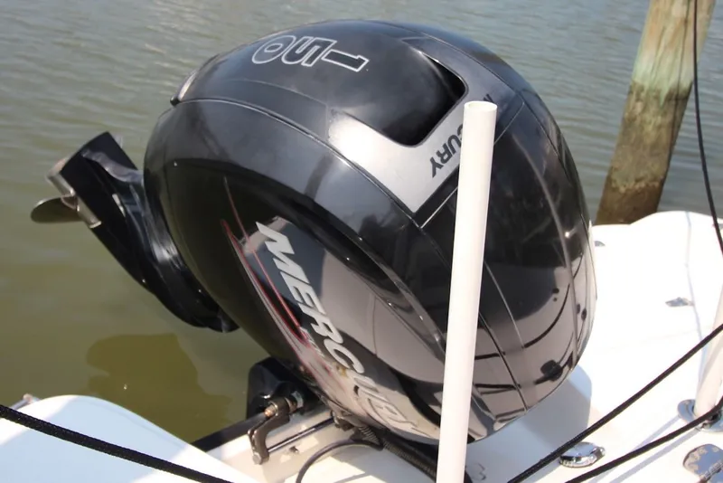 Slide: The Image of Mercury outboard motor on a 2016 Boston Whaler 210 Dauntless boat, docked by water. - 19