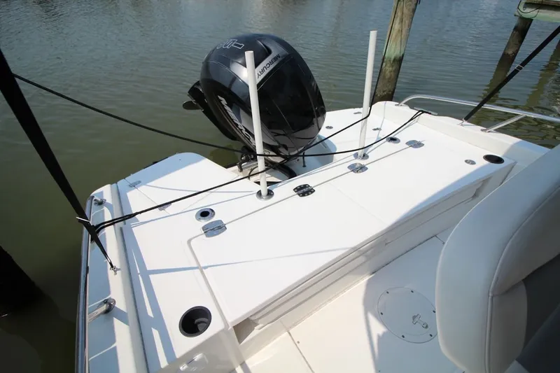 Slide: The Image of 2016 Boston Whaler 210 Dauntless boat with Mercury outboard engine, docked on calm water. - 14