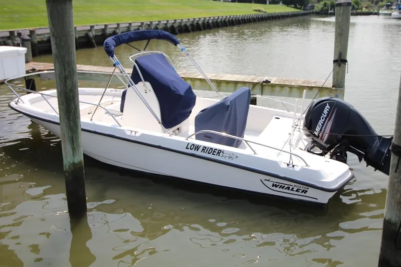 Slide: The Image of 2016 Boston Whaler 210 Dauntless boat docked with Mercury engine. - 2