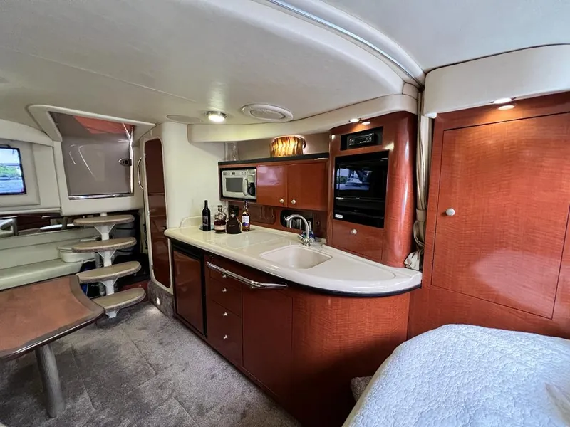 Slide: The Image of Interior of 2005 Sea Ray 340 Sundancer yacht with kitchen and dining area. - 13