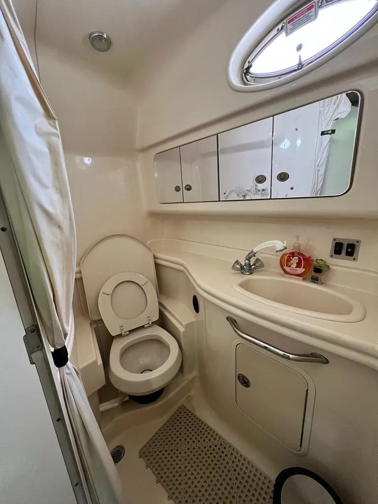 Slide: The Image of Bathroom interior of a 2005 Sea Ray 340 Sundancer boat with toilet and sink. - 15