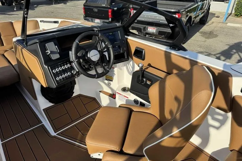 Slide: The Image of Interior of 2027 Moomba Max boat with tan seating and modern dashboard. - 13